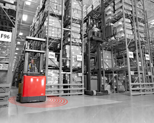 Black and white warehouse graphic with Raymond red forklift showing red rings for geofencing/zoning capabilities. 