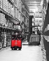 Raymond Courier 3010 Automated Pallet Truck Turning into Aisle in Warehouse